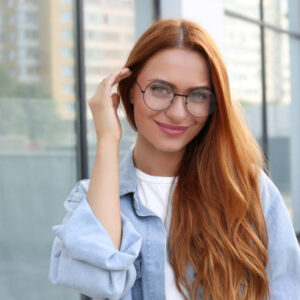 Portrait of beautiful woman in glasses outdoors