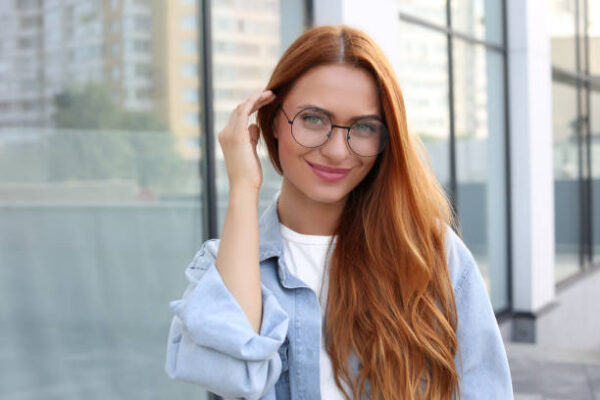 Portrait of beautiful woman in glasses outdoors